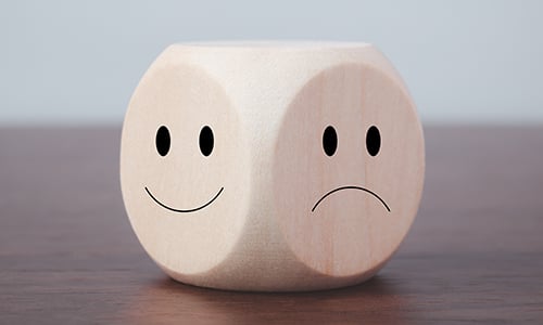Dice with smiley face and sad face