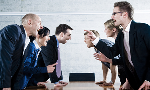 People arguing across a table