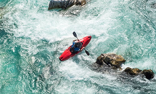 Man kayaking on river soca rapids high angle view