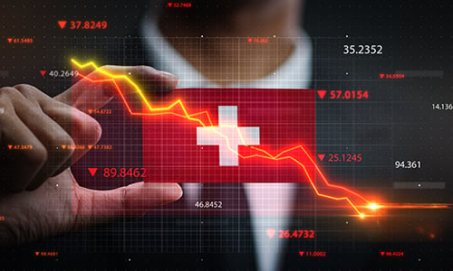 A man holds a Switzerland country flag with the background of floating stock figures which are falling